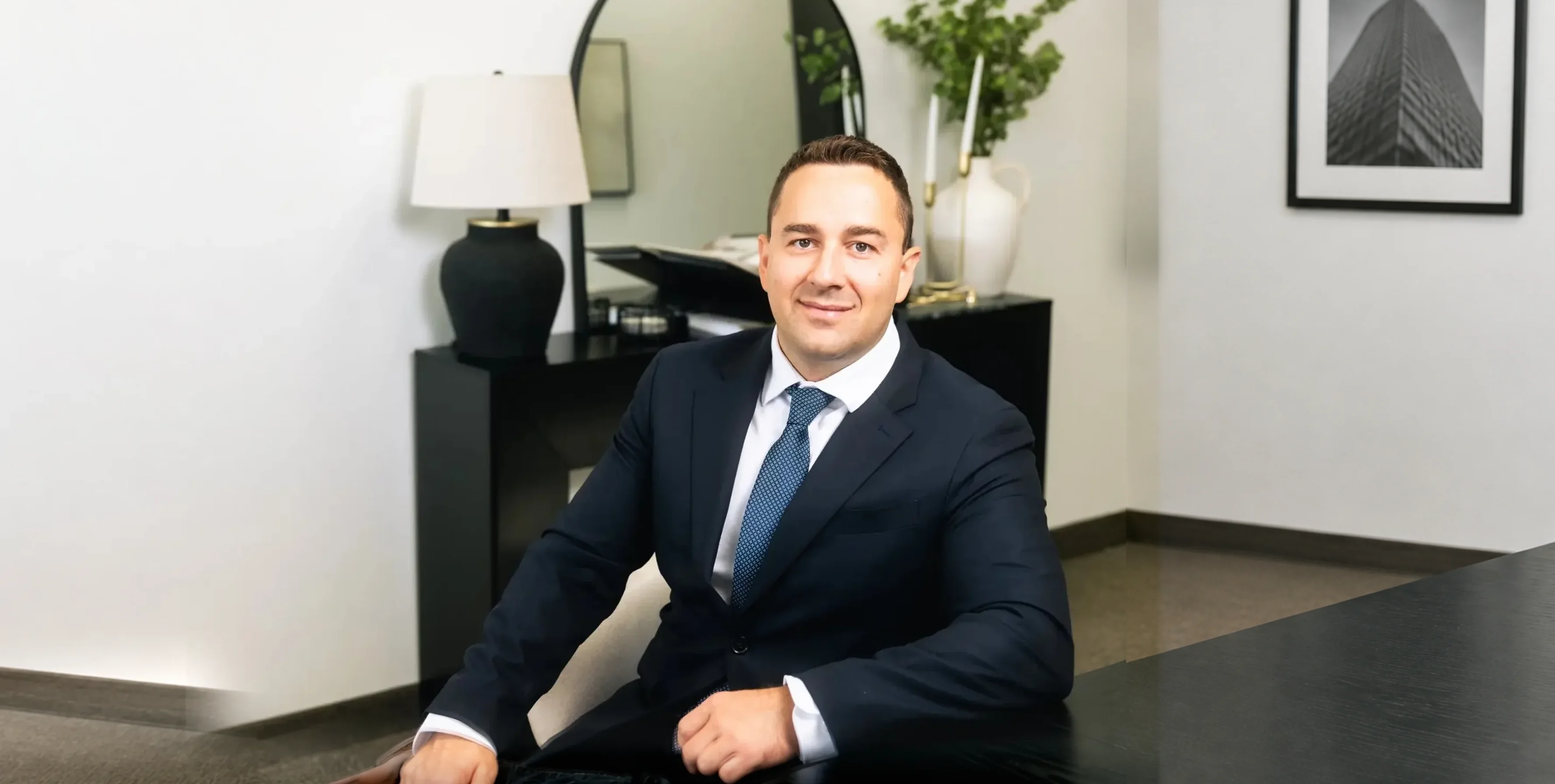 Anthony Krasno, Broker at Estate Mortgage Group, seated in his office